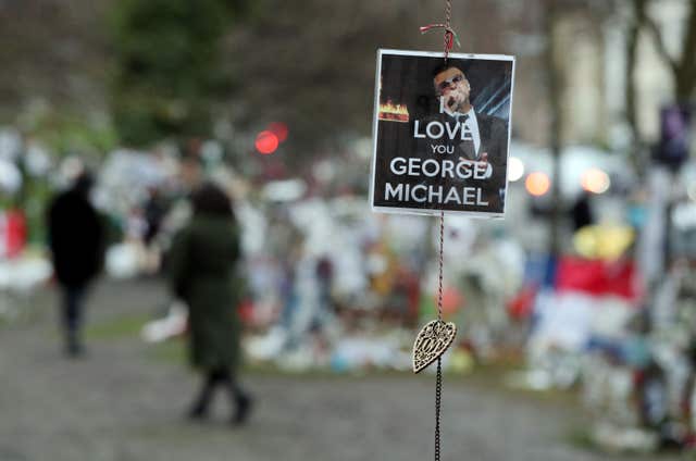 Tributes are left opposite the home of singer George Michael in The Grove, Highgate, London (Jonathan Brady/PA)