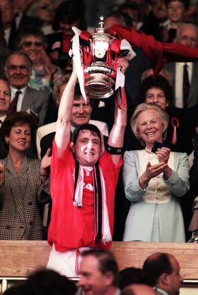Manchester United captain Steve Bruce lifts the FA Cup trophy at Wembley after his side beat Chelsea 4-0 in the final