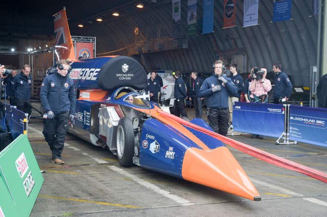 Pilot Andy Green steers as BLOODHOUND SSC is towed out of the hangar by technicians at Newquay airport, Cornwall (Ben Birchall/PA)