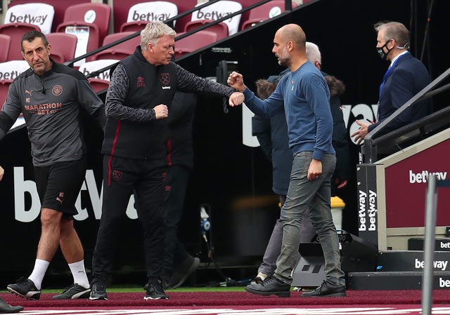 Guardiola (right) feels describing City as Europe's best, as David Moyes (left) believes, is premature