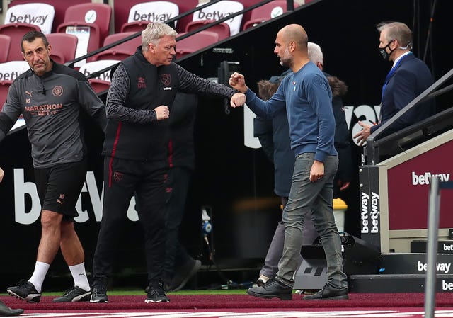 Guardiola (right) feels describing City as Europe's best, as David Moyes (left) believes, is premature