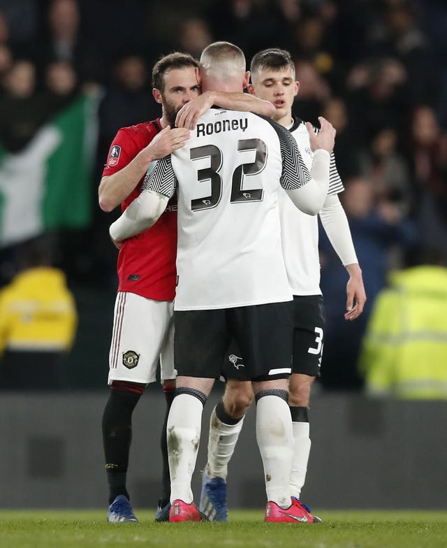 Juan Mata consoled Wayne Rooney after Manchester United won at Derby