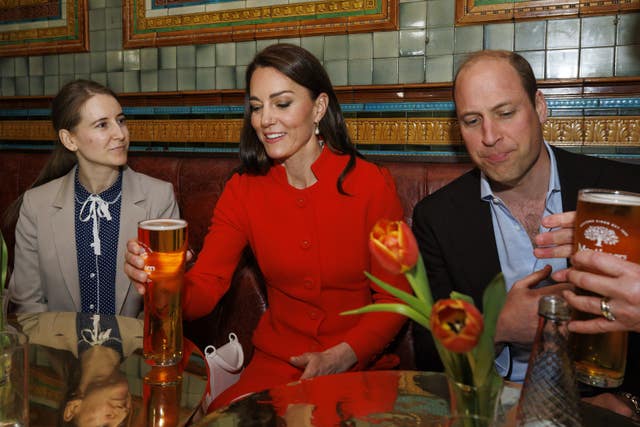 The Prince and Princess of Wales are served a pint of cider as they chat to local business people, during a visit the Dog & Duck pub in Soho