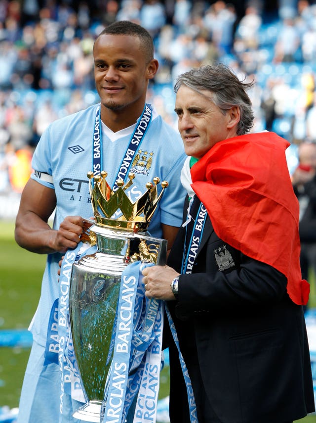Vincent Kompany celebrates the 2012 Premier League title with manager Roberto Mancini