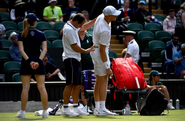 Kyle Edmund receives treatment for a back injury