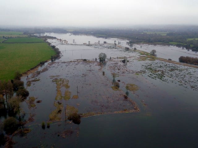 Temperature rises will increase heavy rainstorms which cause flooding (Steve Parsons/PA)
