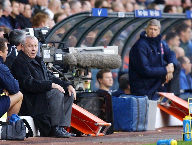 Arsene Wenger (right) watches on 