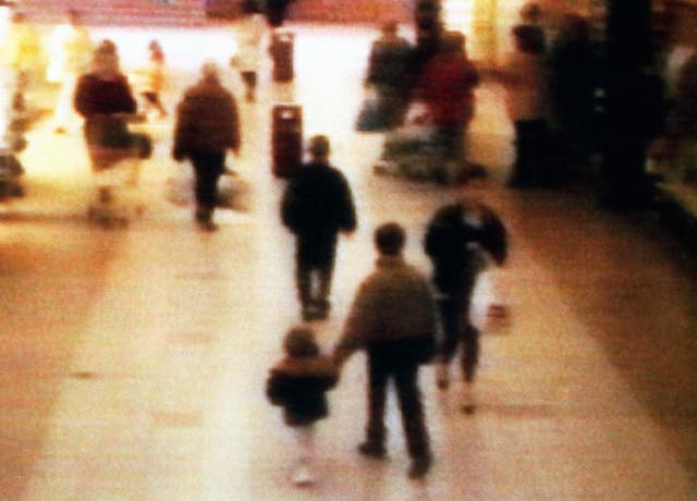 CCTV showing James Bulger being led away in the New Strand shopping centre in the Bootle area of Liverpool in 1993 (PA)
