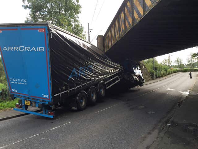 A lorry stuck under a low bridge