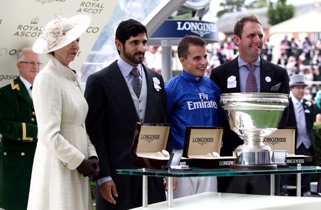 The Princess Royal presents the winner's trophy to William Buick and Charlie Appleby