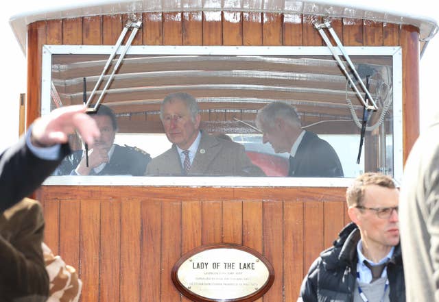 The Prince of Wales takes the wheel in the boat house of the Lady Of The Lake (Peter Byrne/PA)