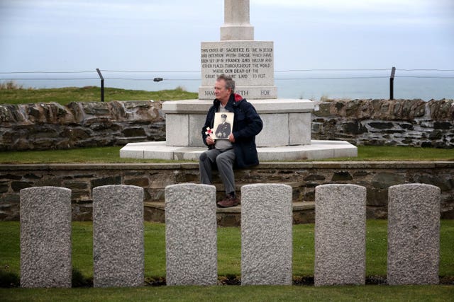 Nick Hide, in the graveyard alongside Kilchoman beach on Islay where his grandfather Captain Ernest Davidson is buried (Jane Barlow/PA)