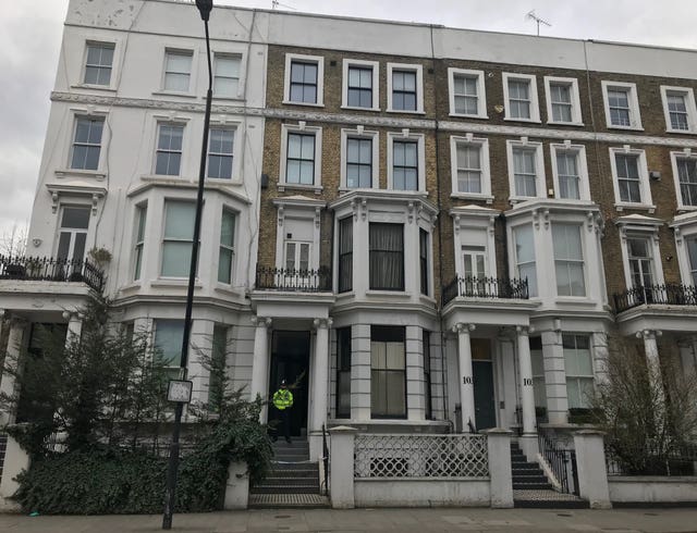 A Police officers outside a house on Earls Court Road (Ryan Hooper/PA)