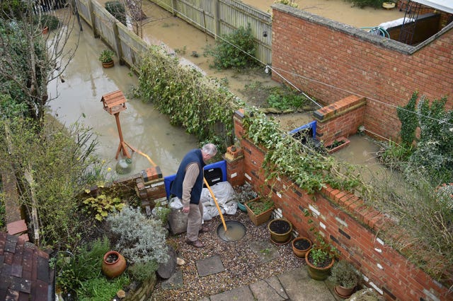 John Badham checks the pumps in his back garden are working (Ben Birchall/PA).