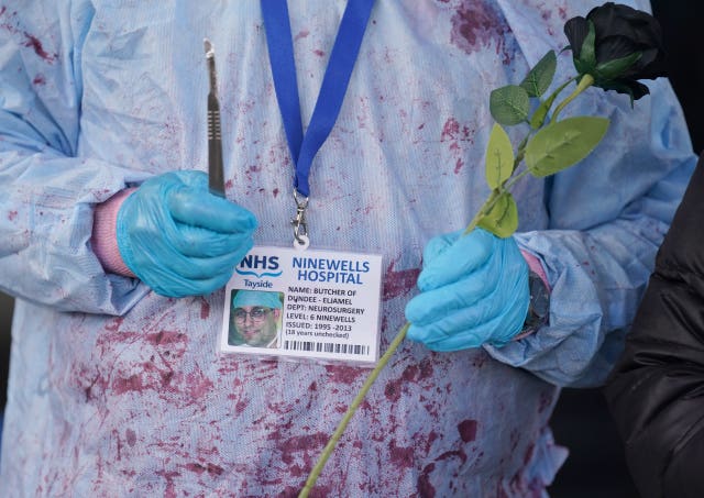 a campaigner taking part in a demonstration outside the Scottish Parliament