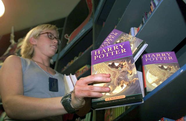 A bookseller stocks the shelves at a UK bookshop
