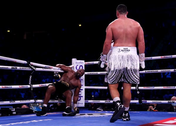 Joseph Parker (right) looks on as Derek Chisora attempts to get back up