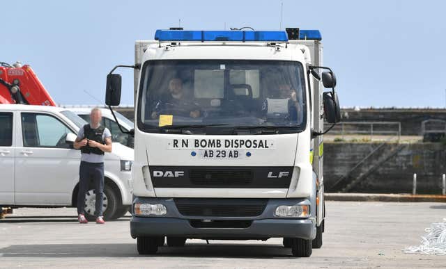 Bomb disposal units and National Crime Agency officers at Newlyn harbour after yacht was seized in the English Channel (Ben Birchall/PA)
