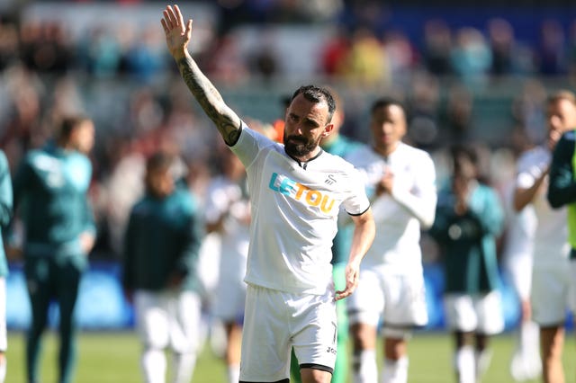 Leon Britton applauds the Swansea fans after playing his last game