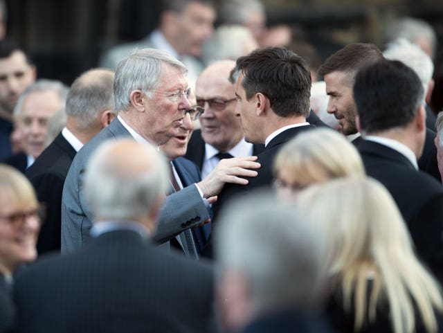 Sir Alex Ferguson, left, and Gary Neville talk after the service