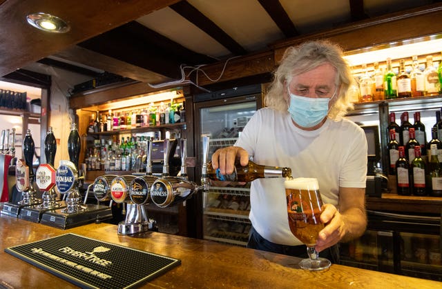 Phil Weaver, owner of The Old Smithy in Church Lawford, Warwickshire pours a pint