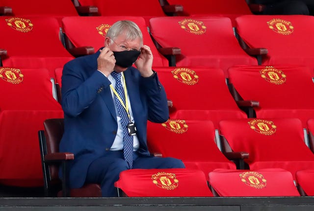 Former Manchester United Sir Alex Ferguson adjusts his face mask at Old Trafford. The 78-year-old watched from the stands as United ... against West Ham