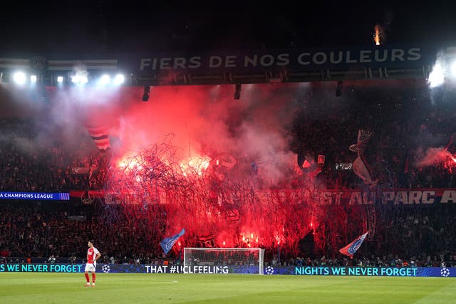 Paris St Germain fans celebrate victory with flares after the final whistle