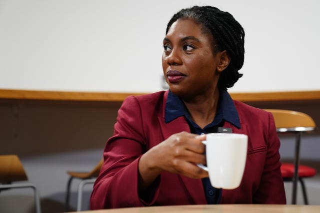 Kemi Badenoch lifts a mug of tea