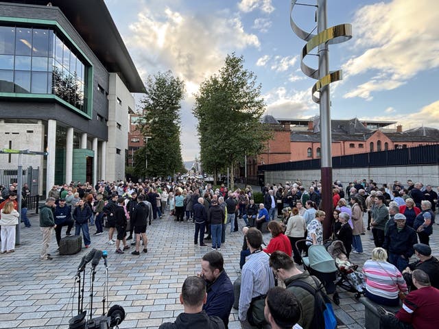 People gathered outside the Royal Courts of Justice in Belfast