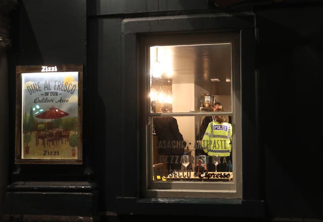 Police inside Zizzi in Castle Street, Salisbury after it closed in connection with an incident which left two people critically ill (Steve Parsons/PA)