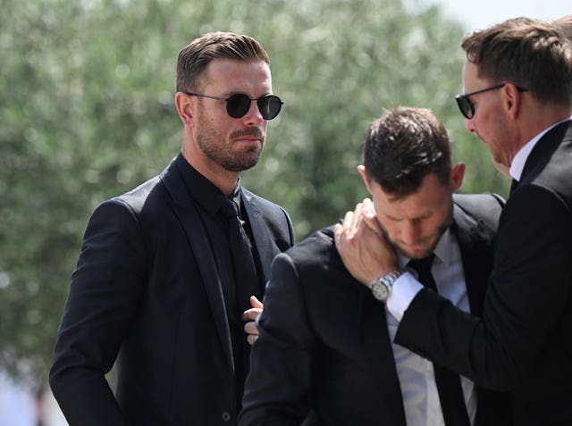 James Milner is comforted while Jordan Henderson watches on