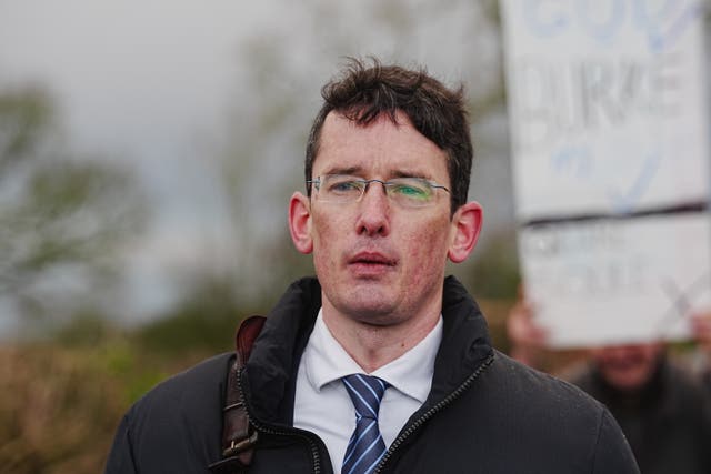 Head and shoulders photo of Enoch Burke walking outside