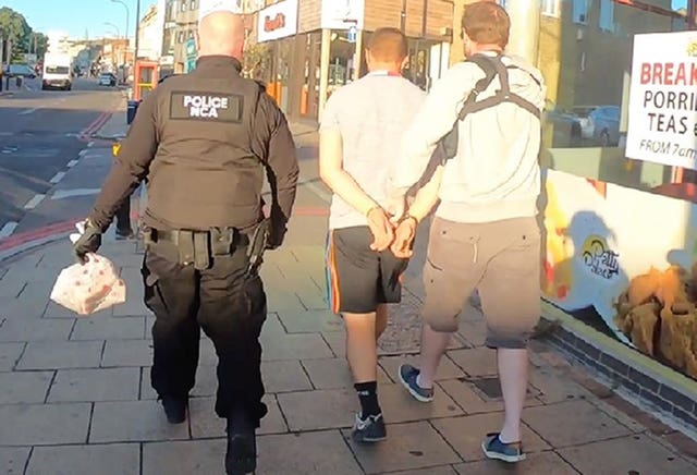 A man being detained as part of Operation Punjum