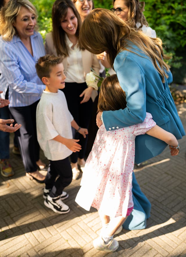 Princess of Wales hugging children