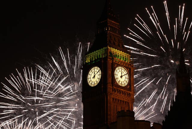 The Queen Elizabeth tower, home to Big Ben, seen on New Year's Eve with fireworks in the background, (Yui Mok/PA)