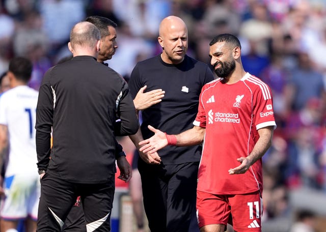 Liverpool’s Mohamed Salah, right, with manager Arne Slot, centre, after being substituted against Crystal Palace