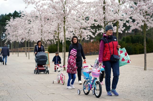 People underneath the blossom at RHS Garden Wisley in Surrey