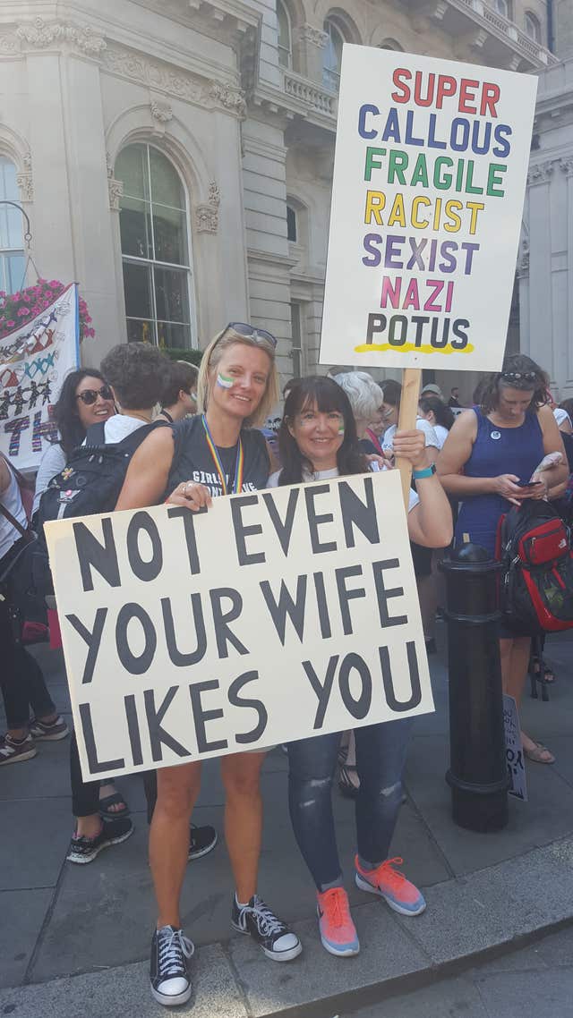 TV comedy writer Lucy Guy (left), 41, with Emily Darnell, 40, hold signs in London, as part of the protests against the visit of US President Donald Trump to the UK.