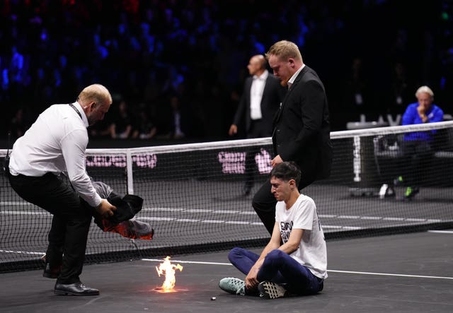 The protester lights a fire on the court