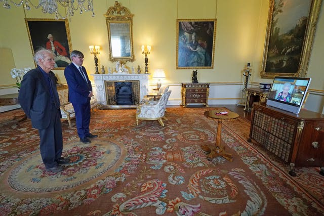 The Queen appears on a screen from Windsor Castle