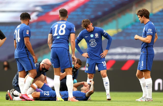 Christian Pulisic lies on the pitch injured during the FA Cup final