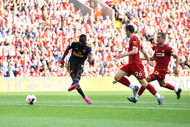 Nicolas Pepe, left, shoots straight at goalkeeper Bernd Leno, not pictured