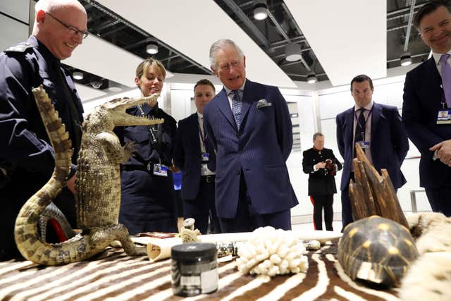 The Prince of Wales is shown items of luggage that have been confiscated during inspections by customs officers during a visit to Heathrow Airport (Chris Jackson/PA)