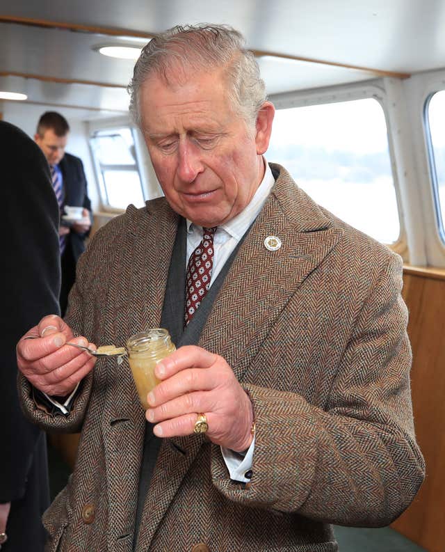 The Prince of Wales tries some marmalade aboard the Lady of the Lake, flagship vessel of the Ullswater Steamers company (Peter Bryrne/PA) 