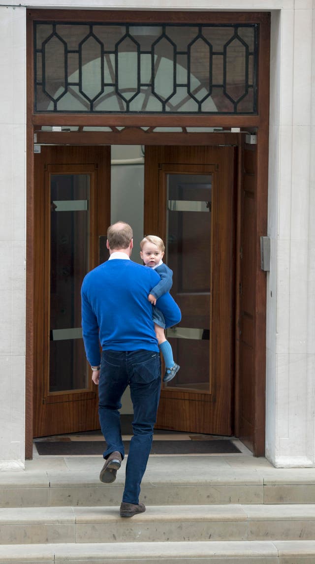 Prince George with his father as he prepares to meet baby sister Charlotte (Anthony Devlin/PA)