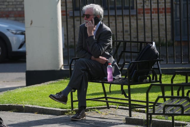 Gerry Adams sitting on a bench