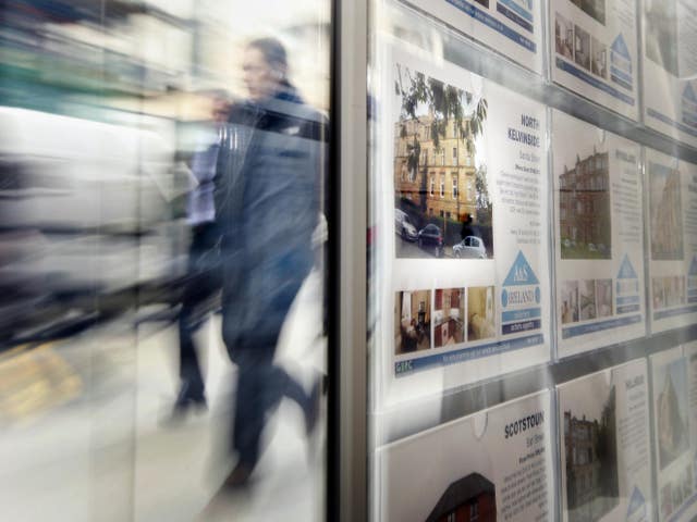 Man walks past estate agents