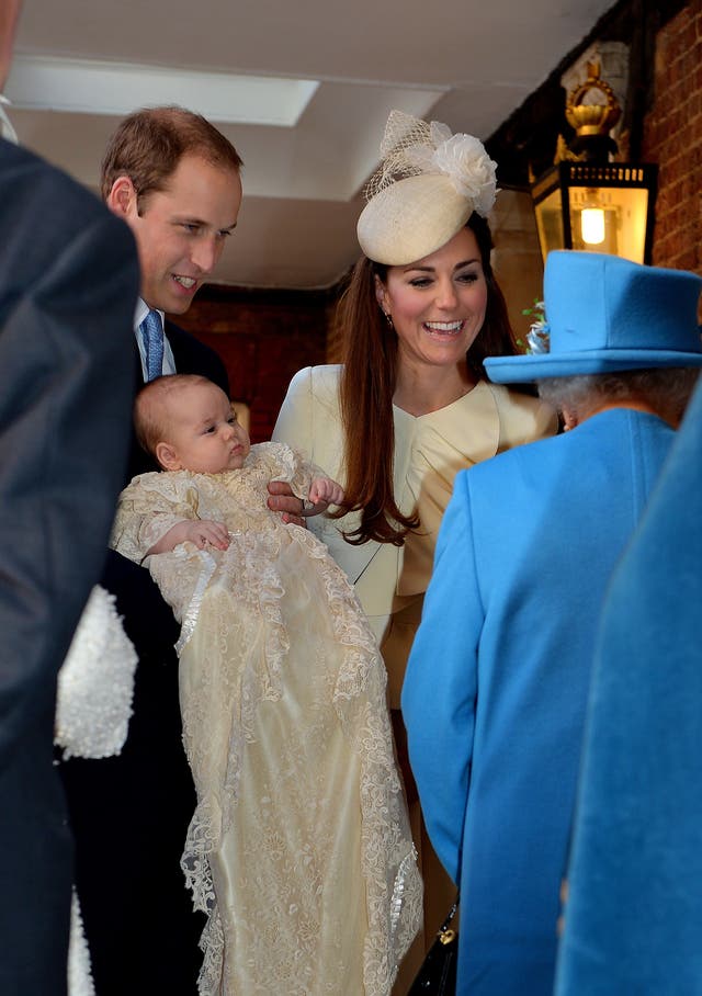 The Queen speaks with the Duke and Duchess of Cambridge at three month-old Prince George's christening (John Stillwell/PA)