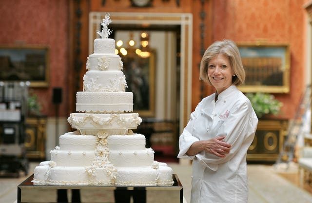 Fiona Cairns stands proudly next to the cake that she and her team made for William and Kate (John Stillwell/PA)