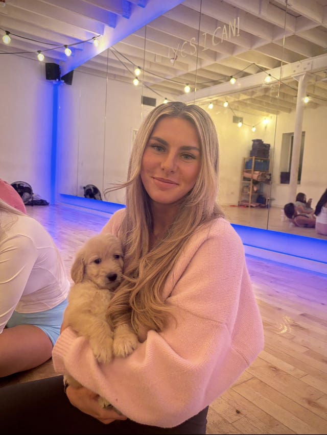 Ami Robertson holding a small dog